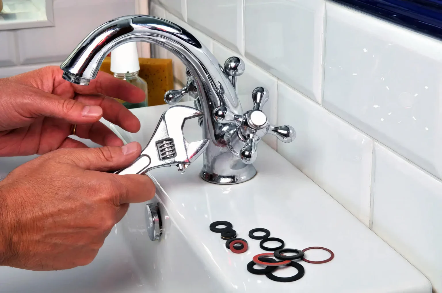 Plumber maintaining a bathroom faucet in Olivehurst