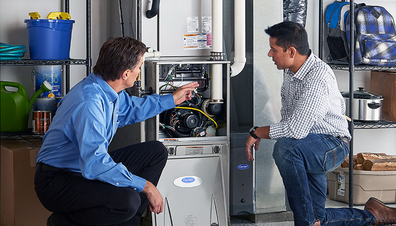 Technician evaluating a furnace for repair or replacement in Olivehurst