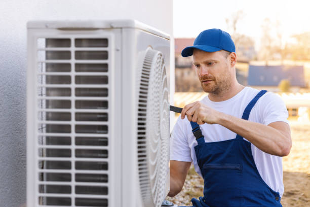 HVAC technician servicing an outdoor air conditioner in Olivehurst