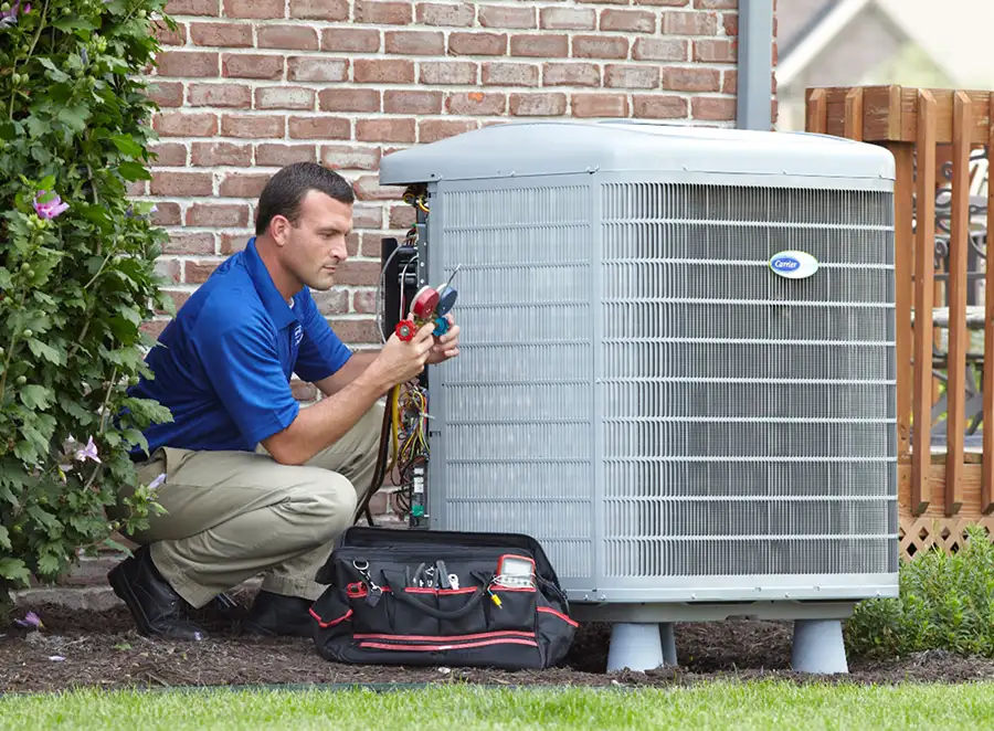 HVAC technician inspecting an outdoor AC unit in Olivehurst