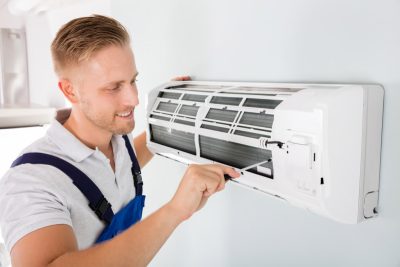 HVAC technician maintaining a ductless air conditioner in Olivehurst